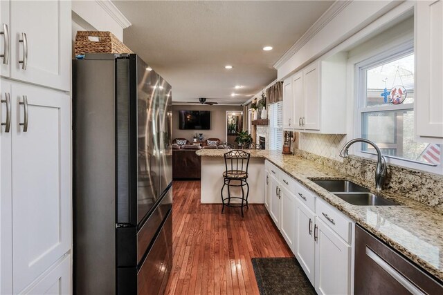 115 Pine Forest Dr, Easley, SC 29642 - kitchen featuring a sink, open floor plan, white cabinetry, stainless steel appliances, and dark wood-style flooring