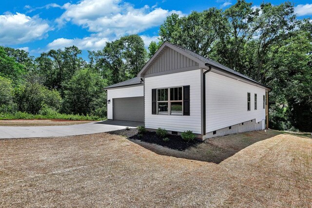 3108 Owens Mills Dr, Anderson, SC 29624 - view of property exterior featuring crawl space, driveway, a garage, and board and batten siding