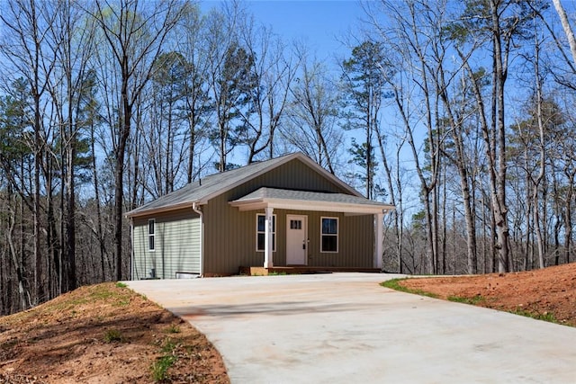 151 Nottingham Dr, Westminster, SC 29693 - view of front of house with a view of trees, roof with shingles, covered porch, and driveway