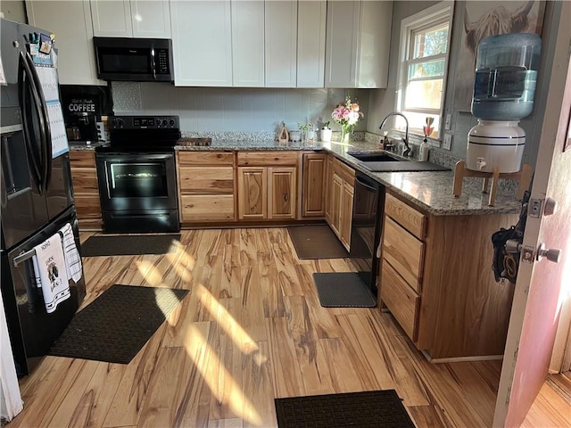 125 Victorian Dr, Anderson, SC 29625 - kitchen with light stone counters, a sink, light wood finished floors, and black appliances