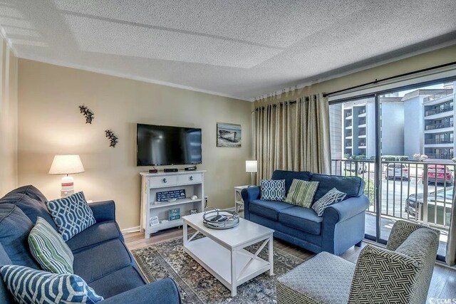 5905 S Kings Hwy Unit 138-A, Myrtle Beach, SC 29575 - living room featuring baseboards, wood finished floors, and a textured ceiling