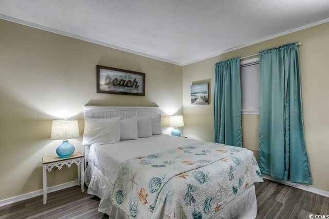5905 S Kings Hwy Unit 138-A, Myrtle Beach, SC 29575 - bedroom featuring baseboards, wood finished floors, and a textured ceiling
