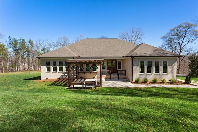 back of house featuring a lawn, a pergola, a patio area, and a shingled roof