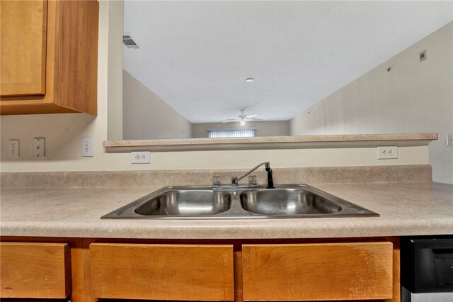 621 Lookover Dr, Anderson, SC 29621 - kitchen with light countertops, a ceiling fan, brown cabinetry, and dishwashing machine