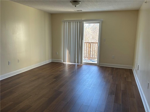 621 Lookover Dr, Anderson, SC 29621 - empty room with healthy amount of natural light, dark wood-type flooring, and a textured ceiling