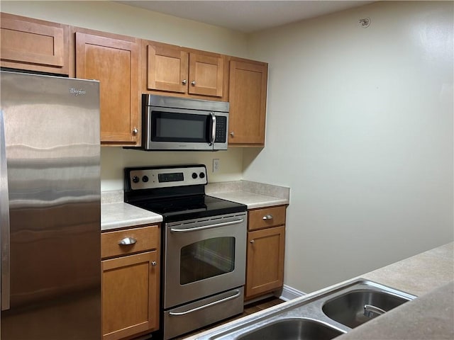 621 Lookover Dr, Anderson, SC 29621 - kitchen featuring stainless steel appliances, brown cabinetry, and light countertops