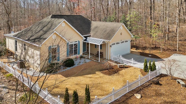 ranch-style house featuring concrete driveway, a shingled roof, fence, and an attached garage