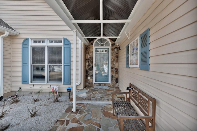 view of exterior entry with a porch