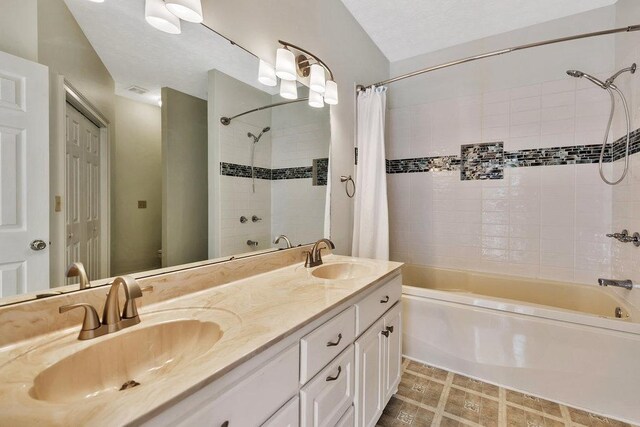 full bathroom with double vanity, a sink, and shower / bath combo