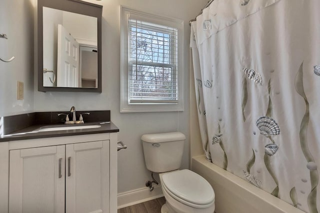 full bath with baseboards, toilet, wood finished floors, vanity, and shower / bath combination with curtain