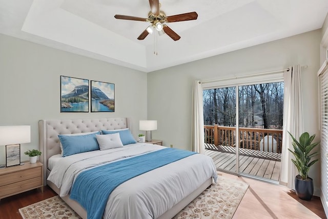 390 Lake Place Dr, Lavonia, GA 30553 - bedroom featuring a raised ceiling, access to outside, wood finished floors, and ceiling fan