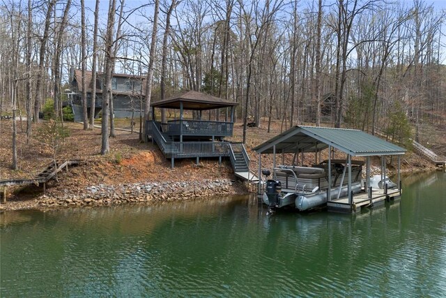 view of dock featuring a deck with water view, a gazebo, and stairway