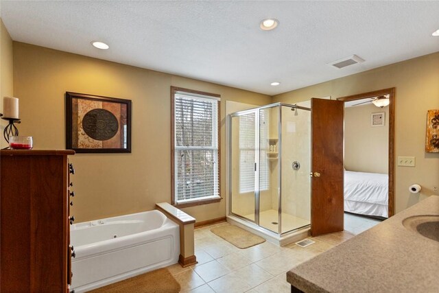 bathroom with a shower stall, baseboards, tile patterned floors, recessed lighting, and a garden tub