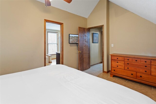tiled bedroom with a ceiling fan, baseboards, and lofted ceiling