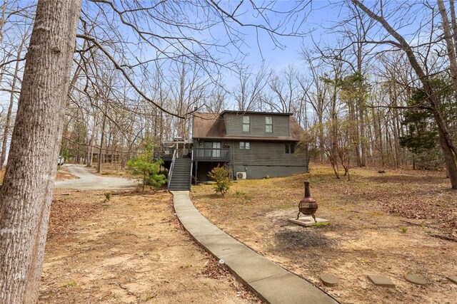 view of yard with stairs and a wooden deck