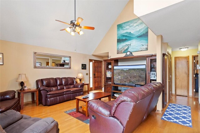 living room featuring high vaulted ceiling, ceiling fan, and wood finished floors