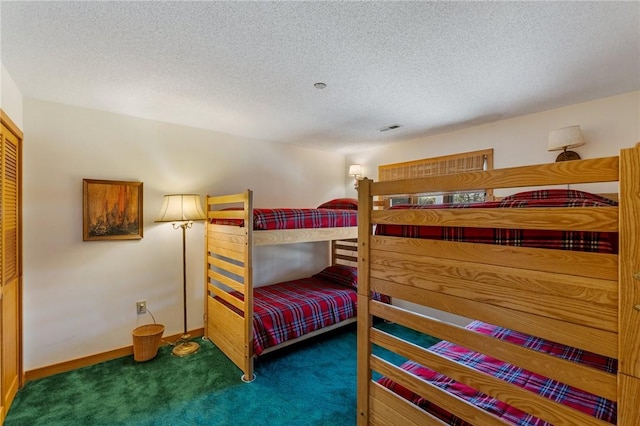 carpeted bedroom featuring baseboards, a textured ceiling, and visible vents