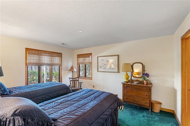 bedroom featuring baseboards, carpet floors, and a textured ceiling