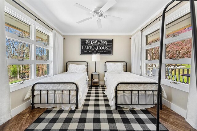 bedroom with baseboards and multiple windows