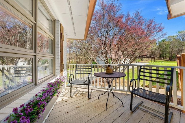 wooden terrace featuring a gazebo
