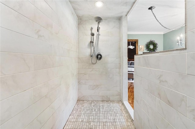 bathroom with crown molding and tiled shower