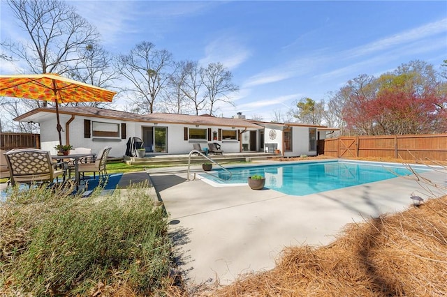view of swimming pool with a patio area, a fenced in pool, and a fenced backyard