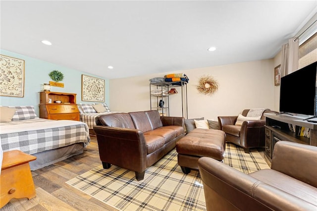 living area featuring light wood finished floors and recessed lighting