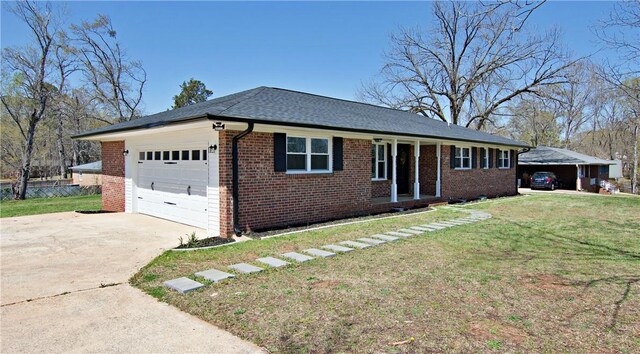 single story home featuring a front lawn, driveway, a garage, and brick siding