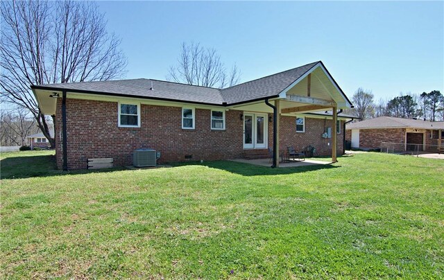 rear view of property featuring brick siding, crawl space, central air condition unit, and a patio