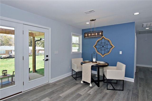 dining room with baseboards, visible vents, wood finished floors, and recessed lighting