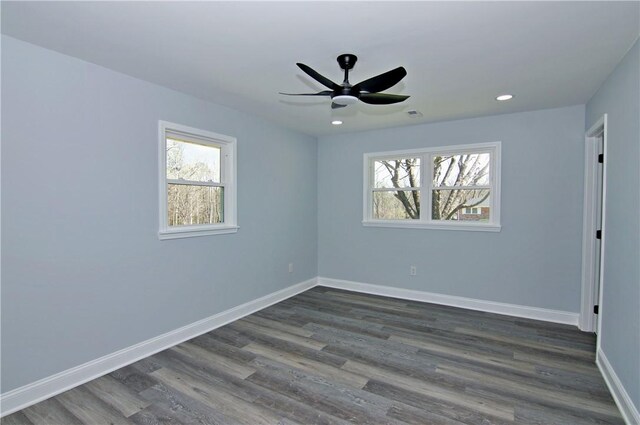 spare room with a ceiling fan, dark wood-style floors, baseboards, visible vents, and recessed lighting