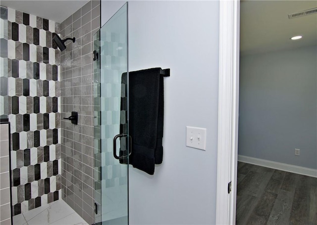 bathroom with a stall shower, wood finished floors, baseboards, visible vents, and recessed lighting