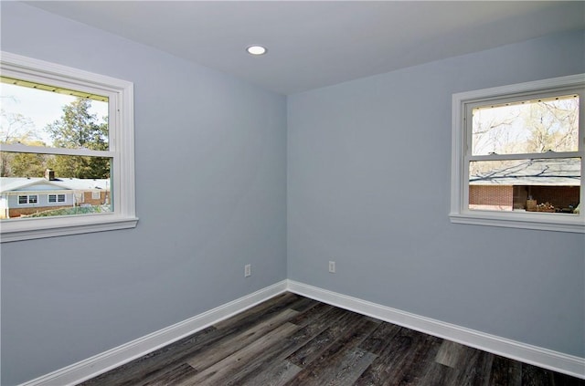 spare room featuring baseboards, recessed lighting, and dark wood-style floors
