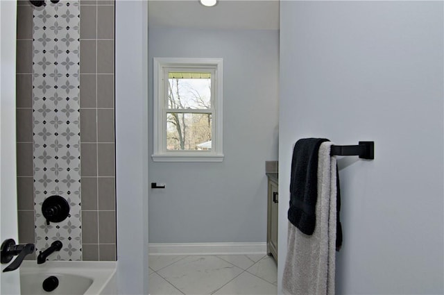full bathroom featuring marble finish floor, baseboards, and  shower combination