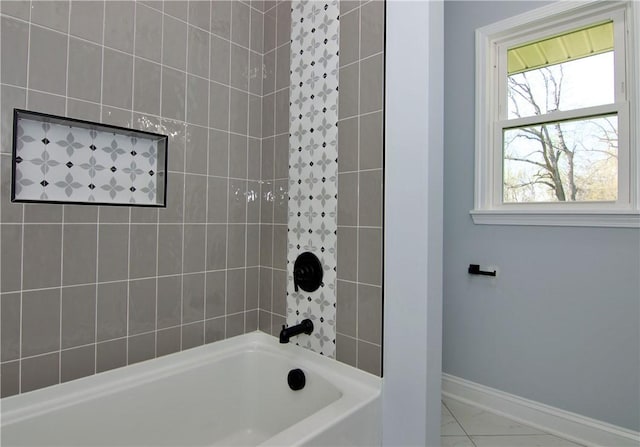 full bathroom with marble finish floor,  shower combination, and baseboards