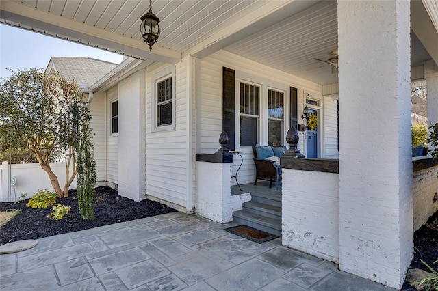 view of patio with a porch and fence