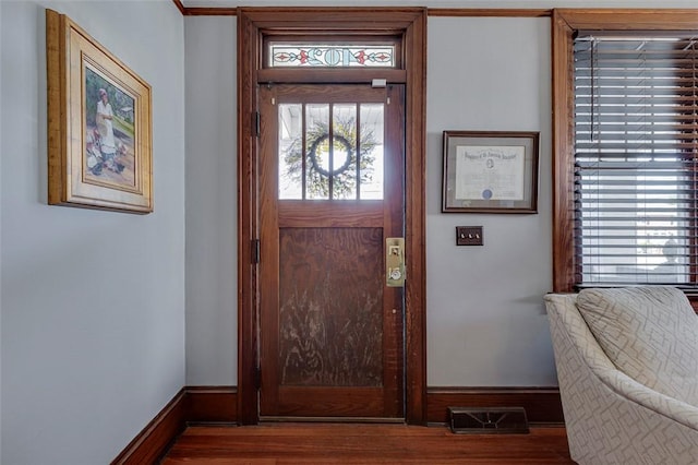 entrance foyer featuring wood finished floors, baseboards, and visible vents