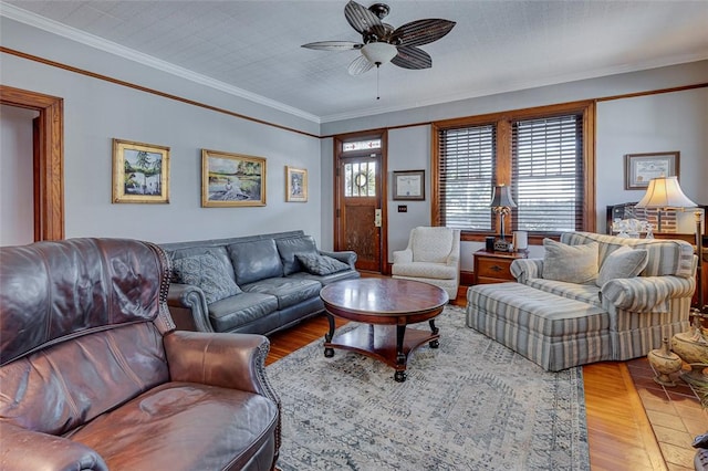 living room featuring ceiling fan, wood finished floors, and ornamental molding