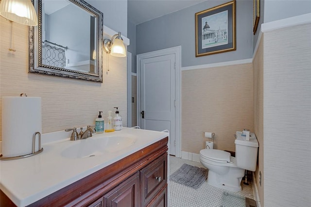 bathroom with toilet, vanity, and tile patterned floors