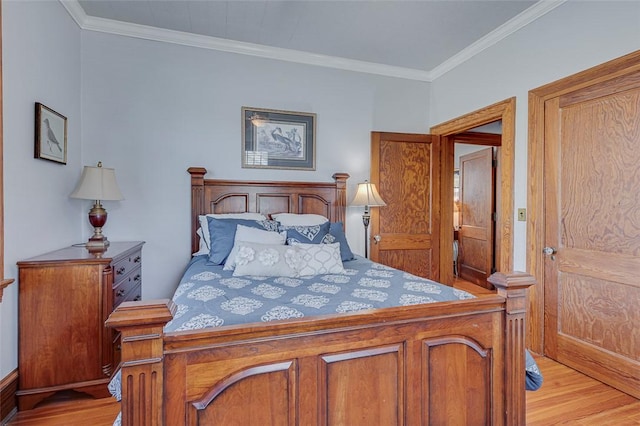 bedroom with ornamental molding and light wood-type flooring