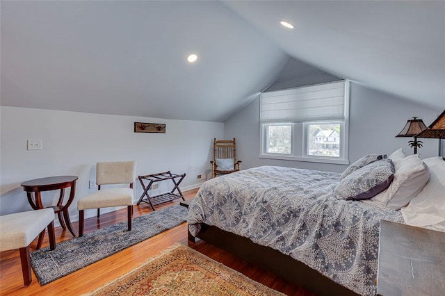 bedroom with baseboards, wood finished floors, vaulted ceiling, and recessed lighting