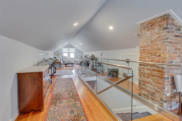 interior space with lofted ceiling, wood finished floors, and recessed lighting