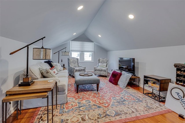 living area with recessed lighting, vaulted ceiling, and wood finished floors