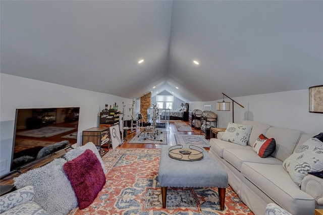 living room with wood finished floors and vaulted ceiling