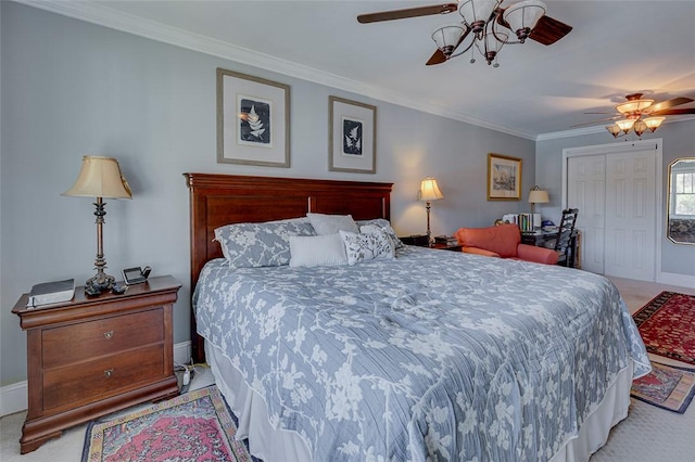 bedroom with crown molding, a closet, light colored carpet, and baseboards