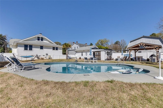 view of swimming pool with an outbuilding, fence, a gazebo, and a fenced in pool