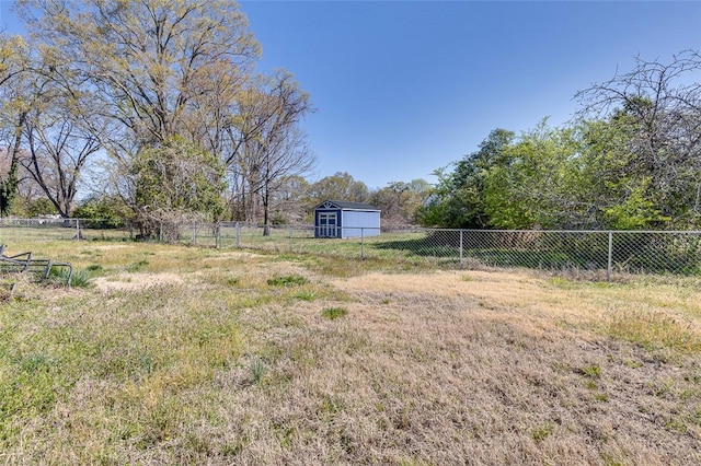 view of yard with fence and an outdoor structure