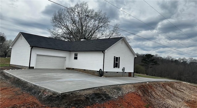 garage with concrete driveway