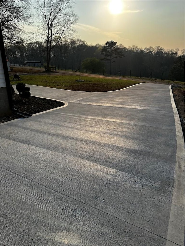view of road featuring view of wooded area