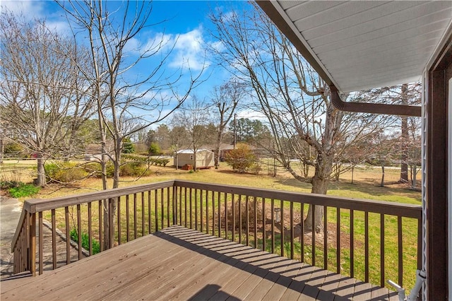 deck with an outdoor structure and a yard